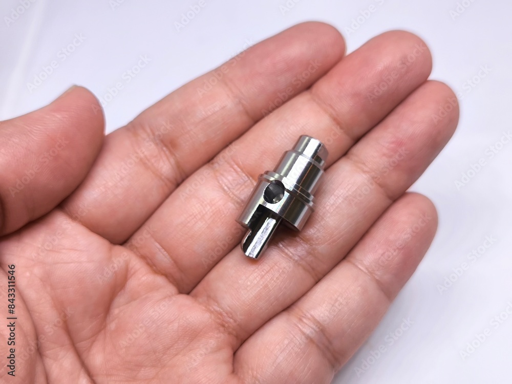 Close up of hand holding metal cnc part. cnc turning parts. Close up of hand holding metal cnc part. cnc turning parts.