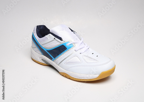 blue and white sports shoes with non-slip rubber sole isolated on light background photo