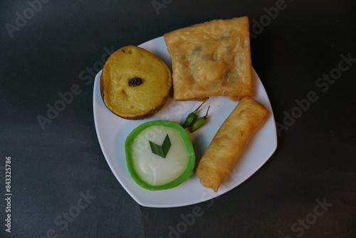 Indonesian traditional snack that called Jajanan Pasar with various color and different taste. The snack name is lumpur risol and martabak telur. photo