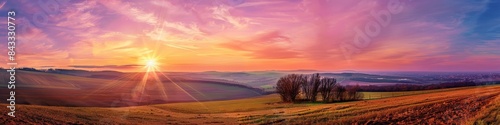 Panorama colorful magnificent sunset in countryside above hills and fields, beauty nature background