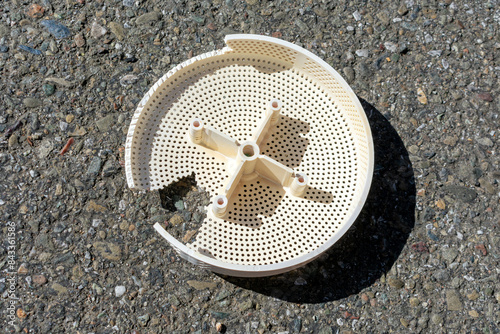 Broken, damaged pool drain cover. Close up.