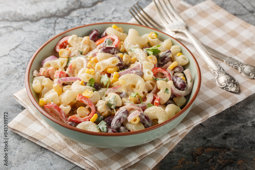 Obraz na płótnie Southwestern elbow pasta salad filled with fresh veggies, red beans, and a zesty dressing close up on the bowl on the table. Horizontal w salonie