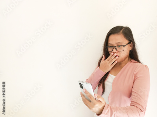 A career woman appears to be smiling at the beginning before her expression changes when she looks at the work report in her office