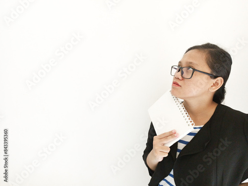 A career woman appears to be smiling at the beginning before her expression changes when she looks at the work report in her office