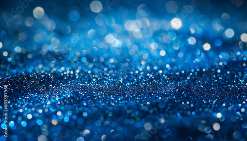 a close up of a blue glittery background with a blurry background