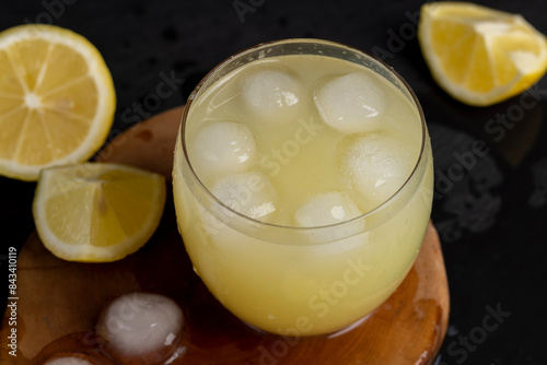 a close-up of lemons and a glass of lemon natural juice