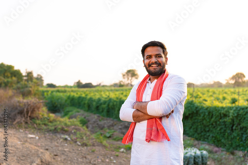 Obraz na płótnie Young indian farmer standing at agriculture field