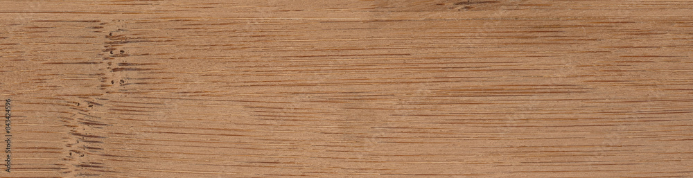 A close up view of a dark bamboo wooden surface. Panoramic wood veneer texture. A close up view of a dark bamboo wooden surface. Panoramic wood veneer texture.