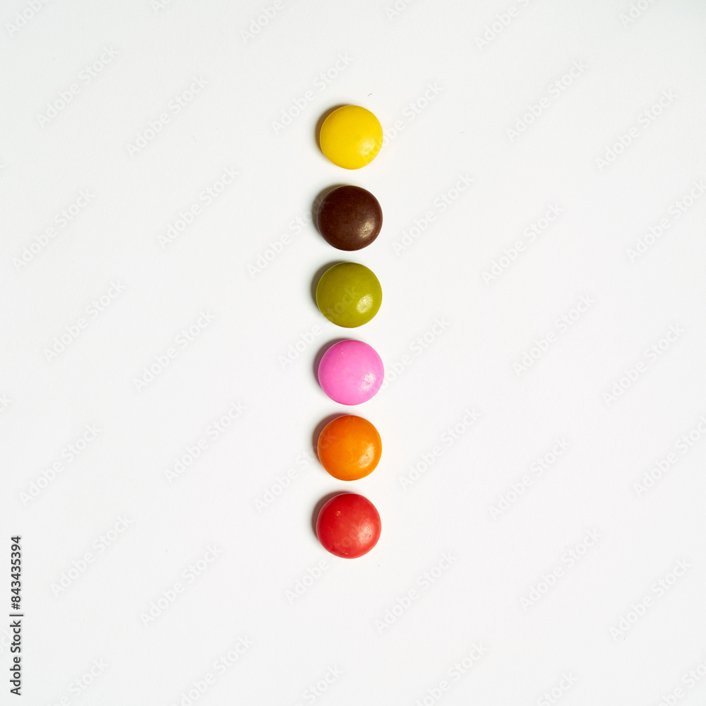Colored chocolate coated candy alphabet on white background. ı,i Colored chocolate coated candy alphabet on white background. ı,i
