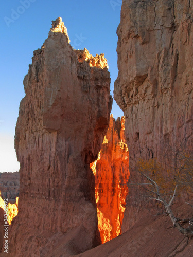 Light shining through two limestone hoodos in Bryce Canyon in Utah USA photo