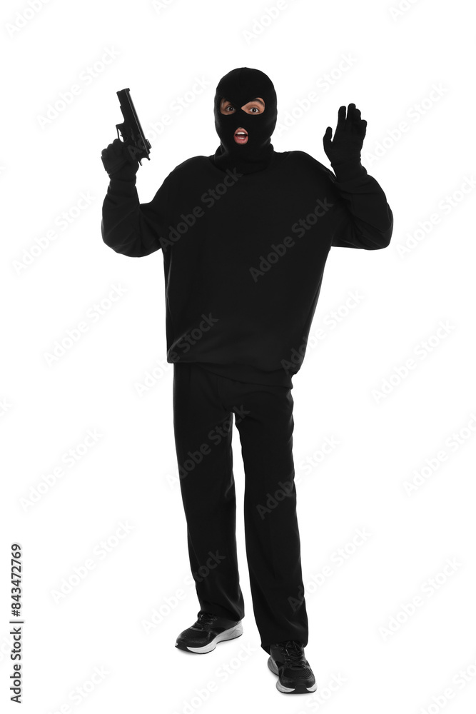 Emotional thief in balaclava with gun raising hands on white background Emotional thief in balaclava with gun raising hands on white background