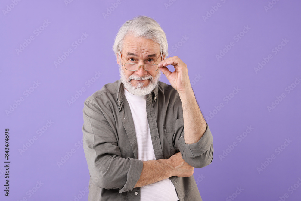 Portrait of stylish grandpa with glasses on purple background Portrait of stylish grandpa with glasses on purple background