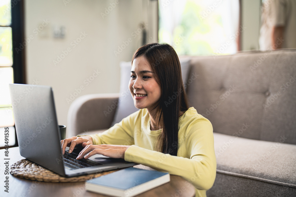 Business woman working from home. work online on laptop. Asian businesswoman working on sofa online business with social distancing laptop online meeting Business woman working from home. work online on laptop. Asian businesswoman working on sofa online business with social distancing laptop online meeting