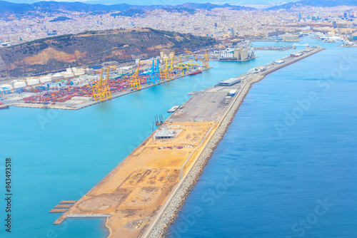 Photography Aerial view of Barcelona port with a massive ship docked, surrounded by containe