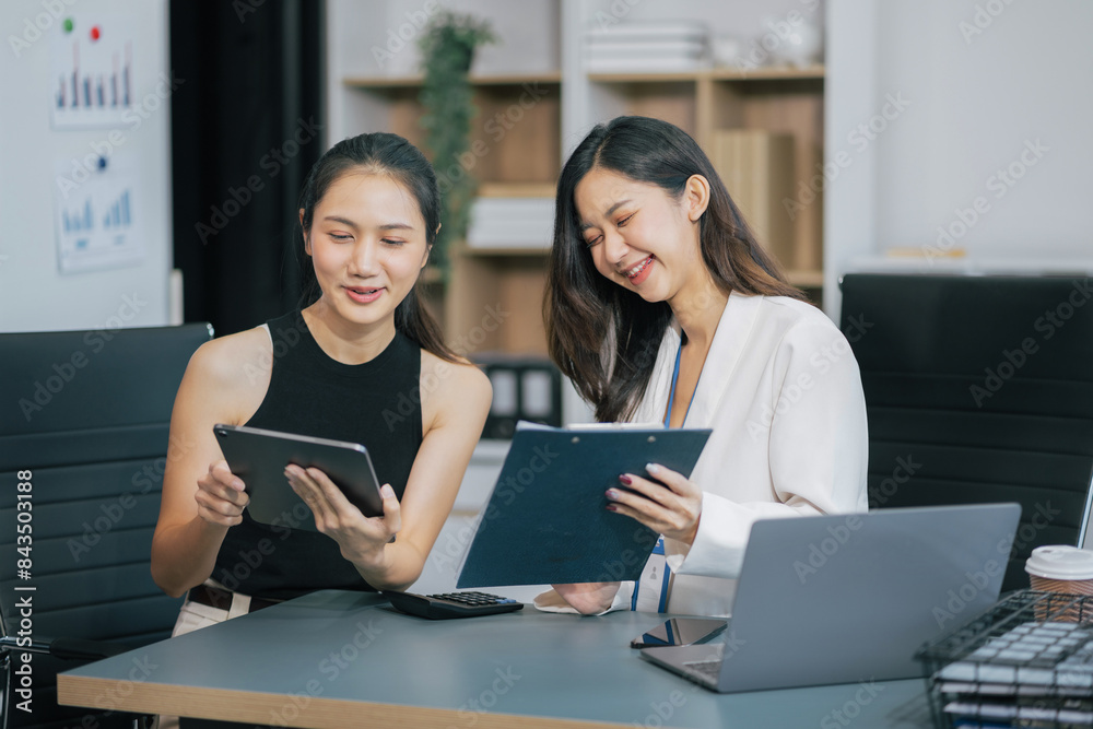 Businesswoman team or financial data analysts working with tablets and laptop computers and data graphs together. Plan to analyzing projects in the office.