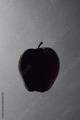 Apple silhouette with dark background.  