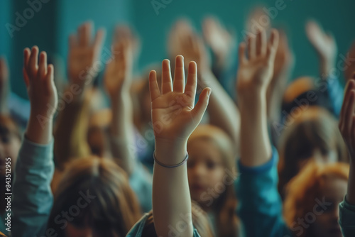 group of children with their hands up to answer a question or ask for something.