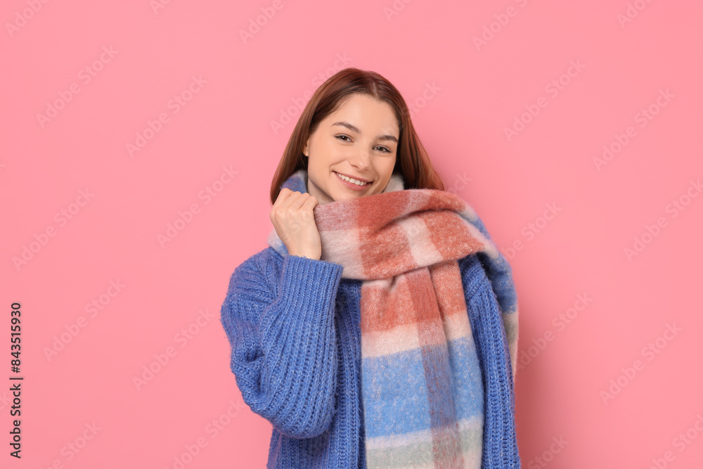 Beautiful woman in warm scarf on pink background Beautiful woman in warm scarf on pink background