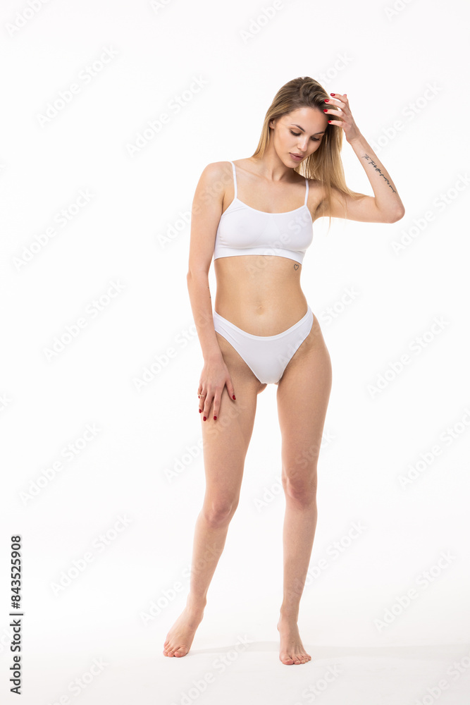 Young pretty girl with slim body posing in underwear against white background. Young pretty girl with slim body posing in underwear against white background.