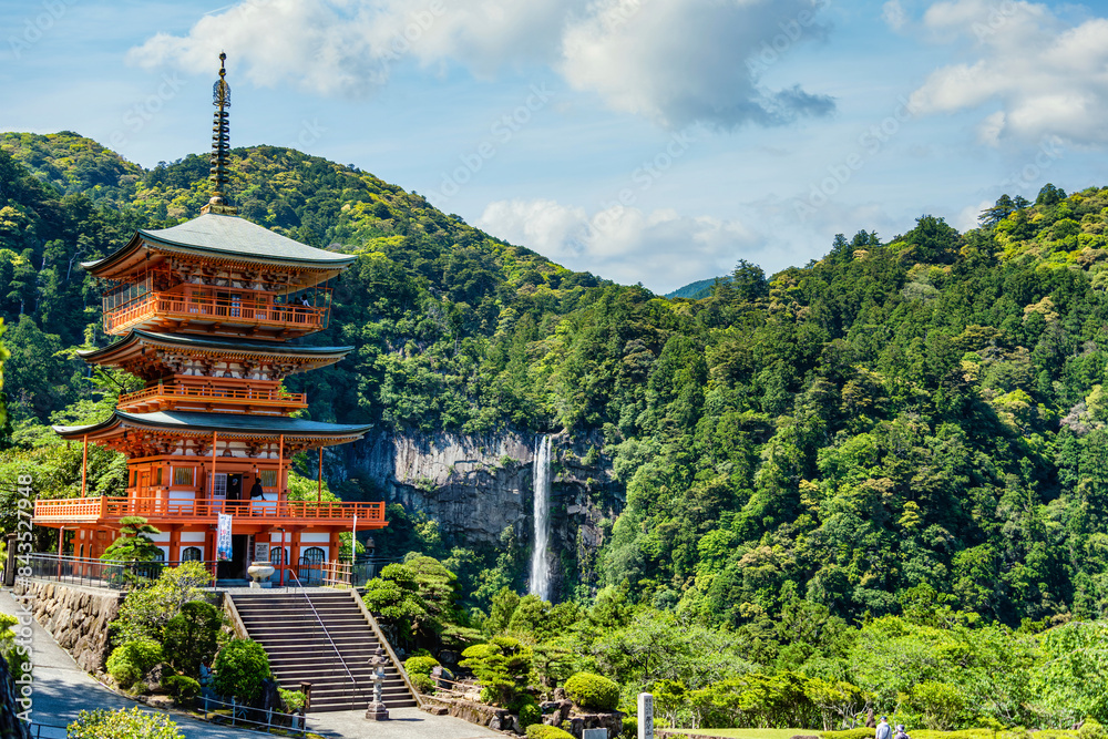 The red three-story pagoda of Seigantoji Buddhist Temple in front of Nachi Falls. Beautiful natural scenery in Nachikatsuura, Japan The red three-story pagoda of Seigantoji Buddhist Temple in front of Nachi Falls. Beautiful natural scenery in Nachikatsuura, Japan