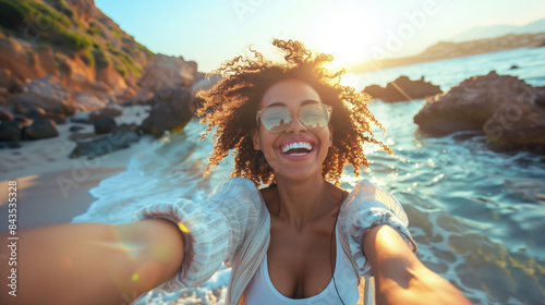 Happy smiling woman taking a selfie through smart phone and enjoying freedom at the beach. Cheerful woman enjoying at beach during holiday. Generative AI. 