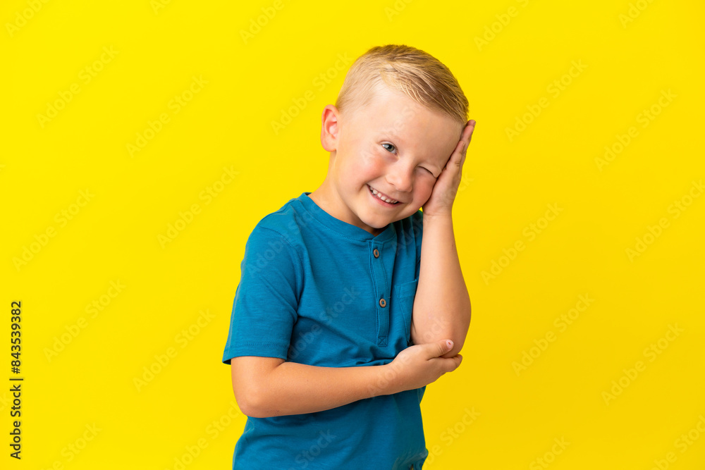 Little Russian boy isolated on yellow background with headache Little Russian boy isolated on yellow background with headache