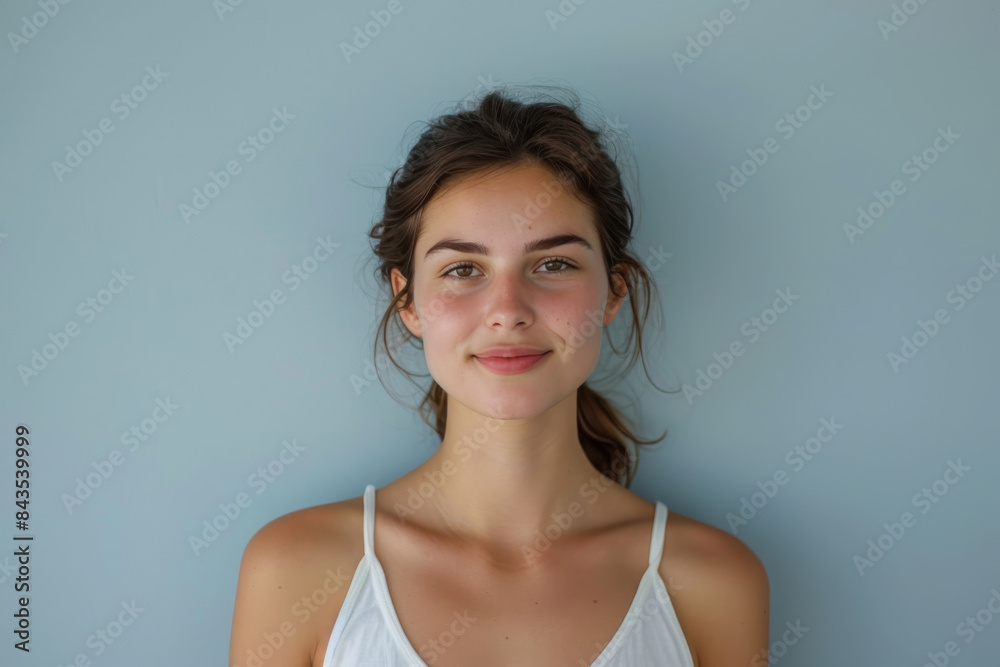 A close up portrait of a young woman with a subtle smile A close up portrait of a young woman with a subtle smile