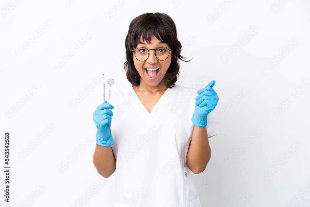 Young woman holding tools isolated on white background celebrating a victory in winner position Young woman holding tools isolated on white background celebrating a victory in winner position