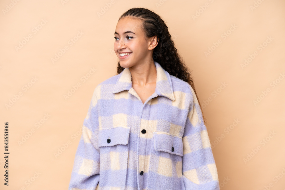 Young woman isolated on beige background looking side Young woman isolated on beige background looking side