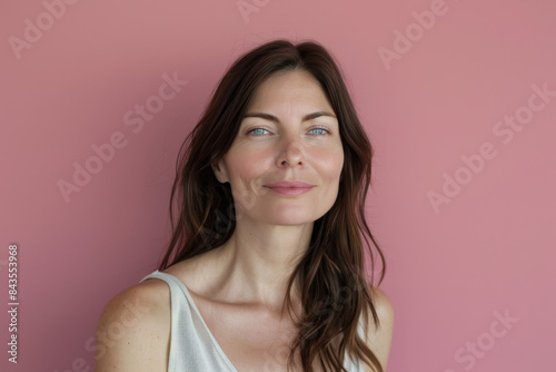 A close up portrait of a young woman with a subtle smile