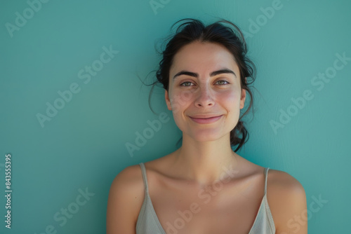 A close up portrait of a young woman with a subtle smile