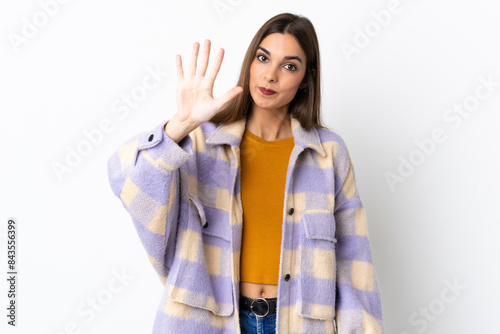 Young caucasian woman isolated on purple background counting five with fingers