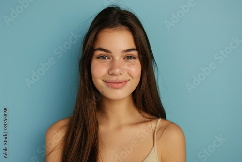 A close up portrait of a young woman with a subtle smile