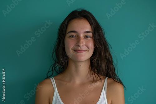 A close up portrait of a young woman with a subtle smile