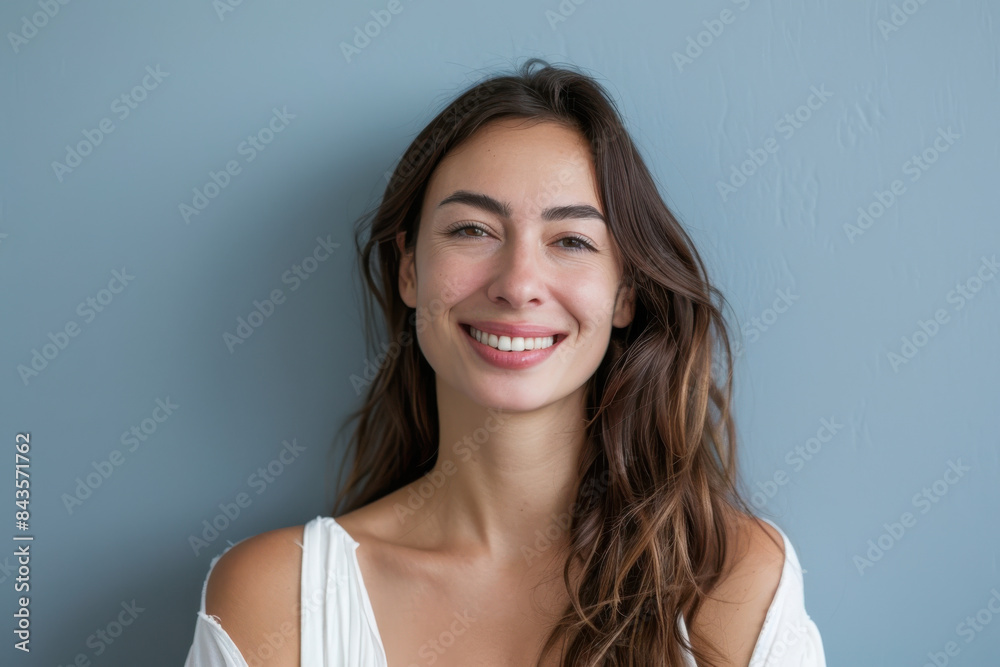 A close up portrait of a young woman with a subtle smile A close up portrait of a young woman with a subtle smile