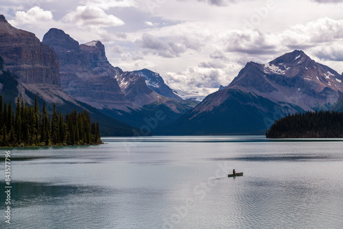 One man in the middle of nature, canoe on Maligne Lake seen from Spirit Island, Jasper national park, Canada.
