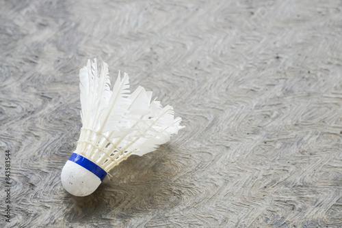 A close up photo of a used shuttlecock which has been used repeatedly with its feathers starting to deteriorate and no longer suitable for use. Concept for Badminton Practice