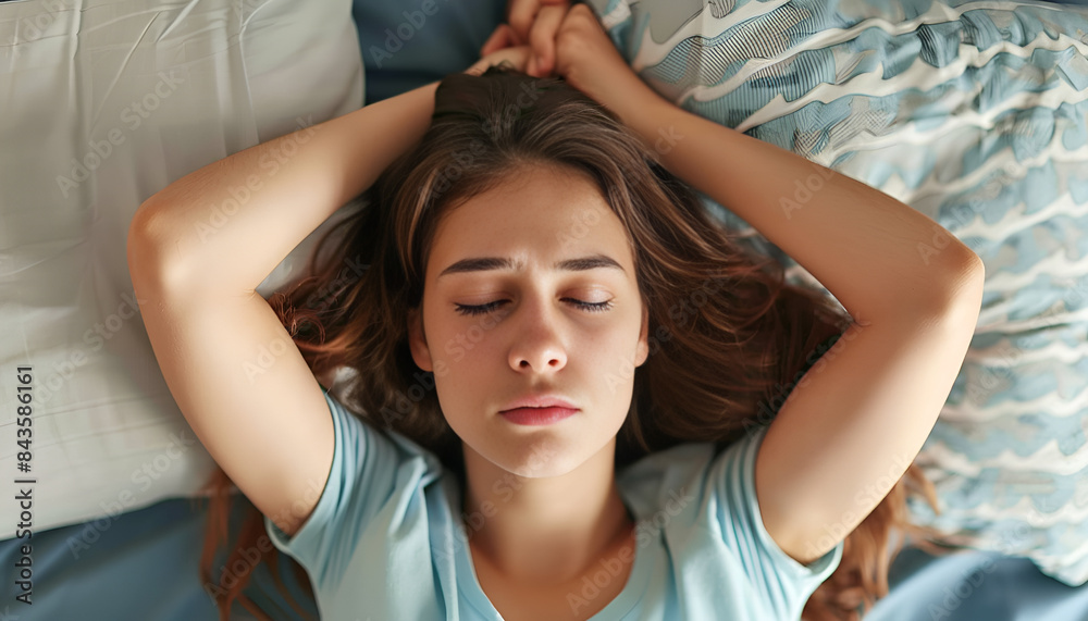 Fototapeta premium Young woman suffering from insomnia at home, above view. Bedtime