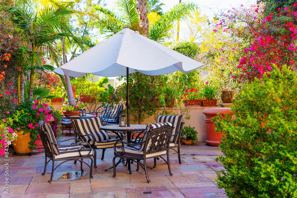 Elegant Outdoor Patio Dining Set Amidst Lush Garden Blooms Elegant Outdoor Patio Dining Set Amidst Lush Garden Blooms