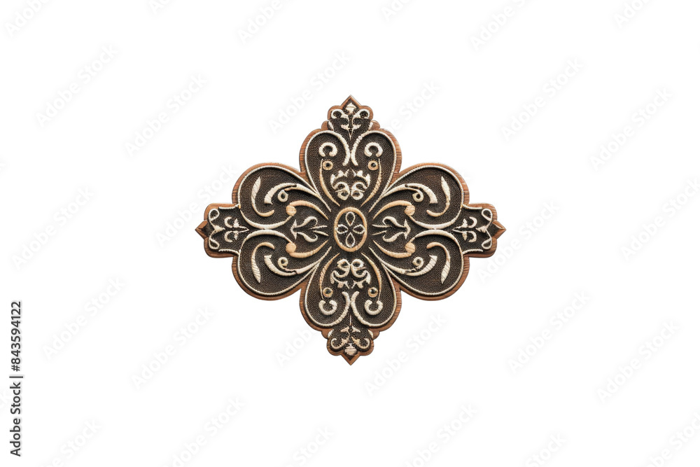 Fototapeta premium Ornate brass cross-shaped decoration with intricate carvings on a black background, ideal for decorative and artistic design projects.
