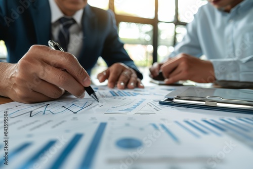Wallpaper Mural Unrecognizable business guys discussing financial audit results with charts and graphs on a desk in their office Torontodigital.ca