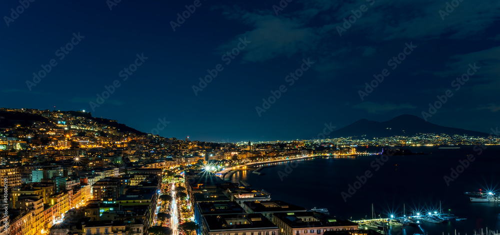 Naklejka premium beautiful night panorama of Naples city with nice lights streets flashlights and buildings and volcano Vesuvius with amazing sky on background