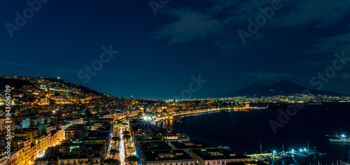 Fototapeta Naklejka Na Ścianę i Meble -  beautiful night panorama of Naples city with nice lights streets flashlights and buildings and volcano Vesuvius with amazing sky on background