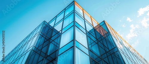 Closeup of a sleek, sharpedged building facade with a mix of glass and metal photo