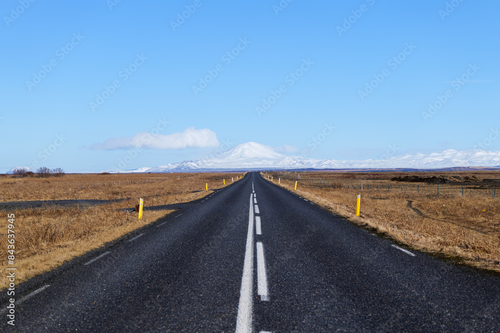 Road in Iceland and Snowy Hekla Volcano with Blue Sky Road in Iceland and Snowy Hekla Volcano with Blue Sky