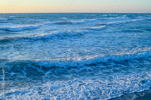 waves and sea foam in the Mediterranean Sea in Cyprus at sunset