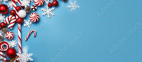 A Christmas themed border displaying white and red decorations including balls gifts candy canes and snowflakes set against a blue background The image is taken from a top down perspective with a fla