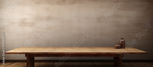 In the room there is a wooden table placed in front of a wall providing ample copy space for images