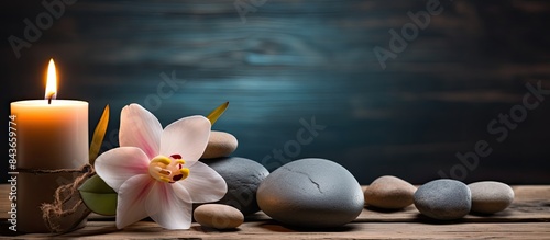 Spa still life with stones flower and candlelight on wooden background. copy space available