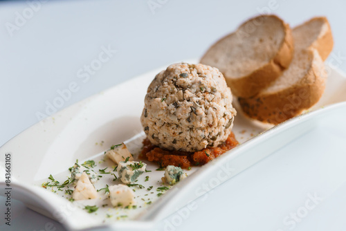 Cheese balls with herbs on a black board on a white background